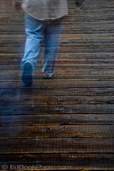 man walking away across wooden planks ghost